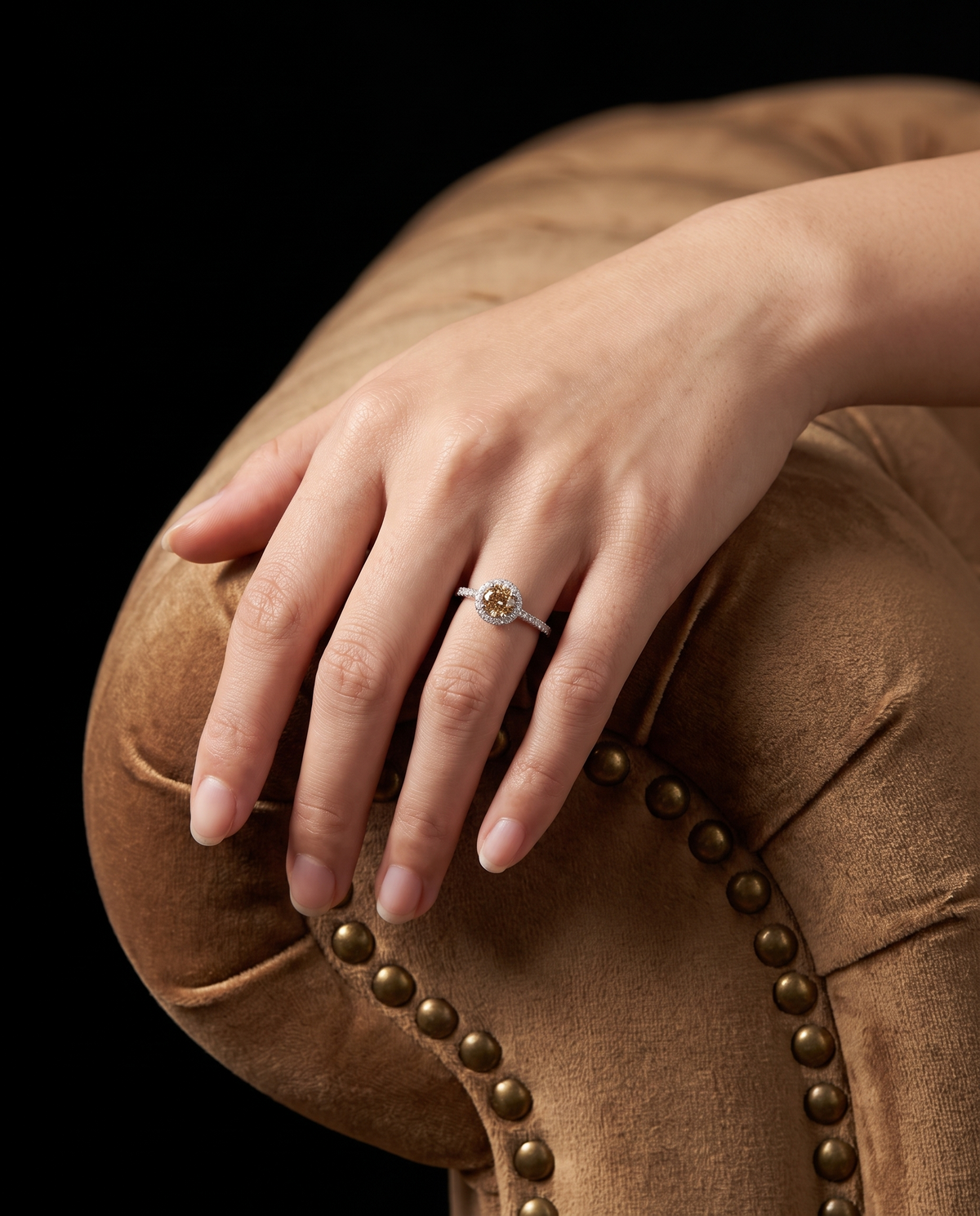 Champagne diamond ring worn on a model's hand