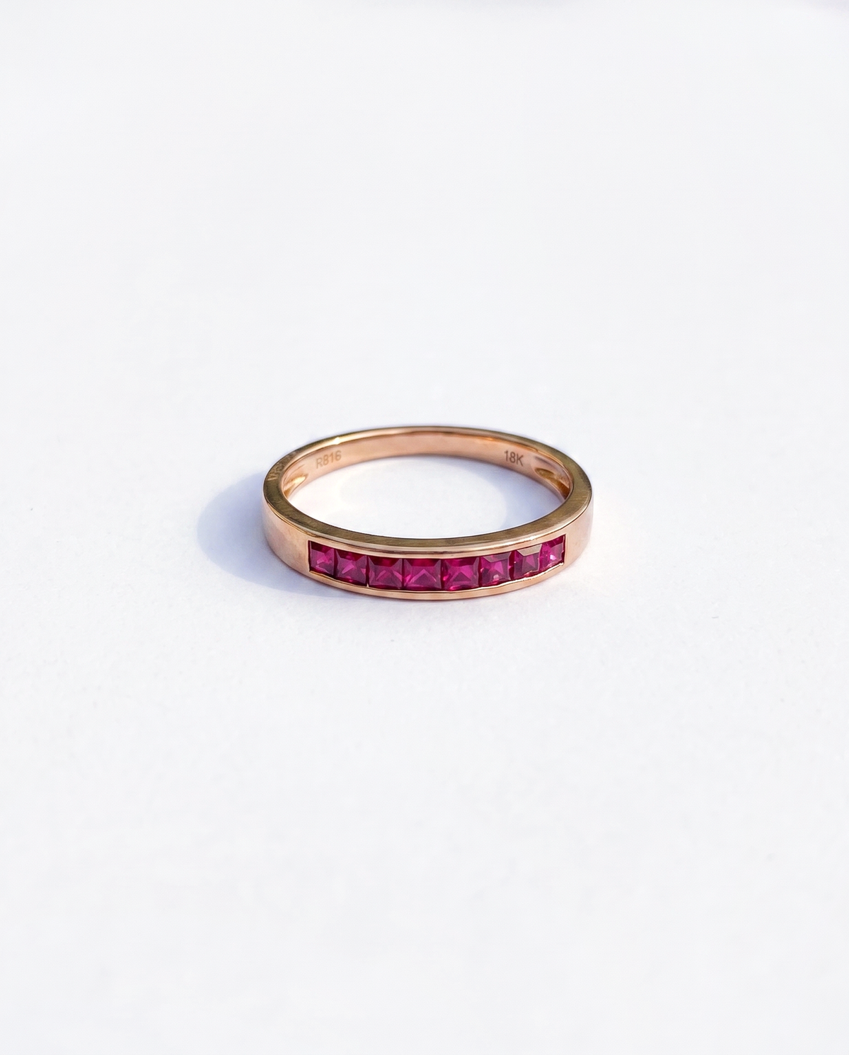 Ruby Channel, 18K yellow gold ring set with rubies, overhead view looking down through the band