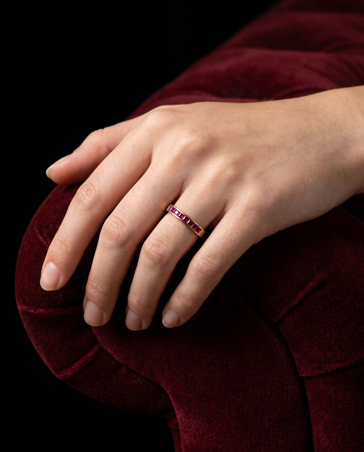 Ruby Channel, 18K yellow gold ring set with rubies, worn on a hand at true scale