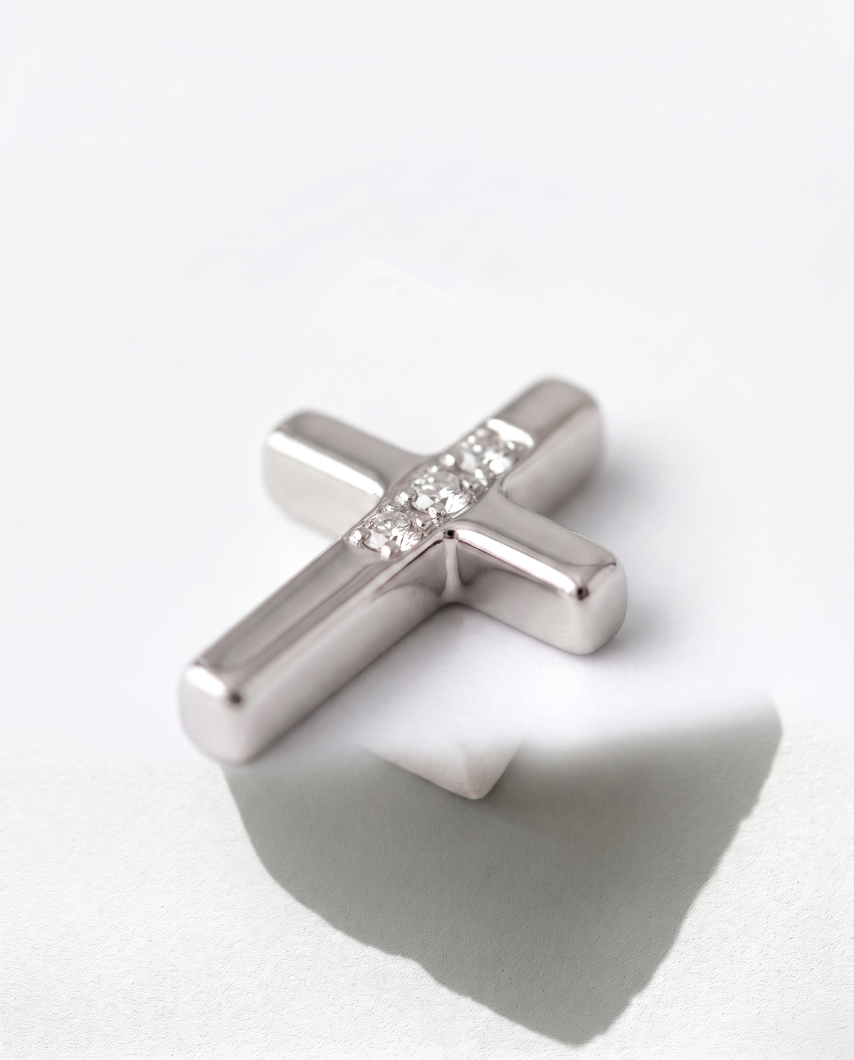 Small Cross pendant, close-up macro of the surface detail